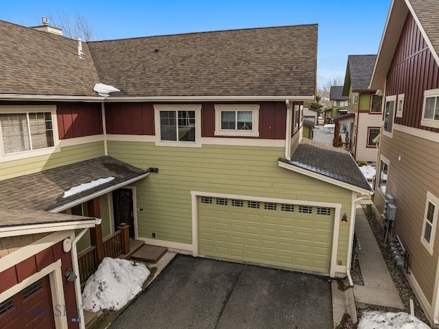2236 Gallatin Green Blvd Unit C, Bozeman, MT 59718 - view of front facade featuring an attached garage, a shingled roof, and driveway