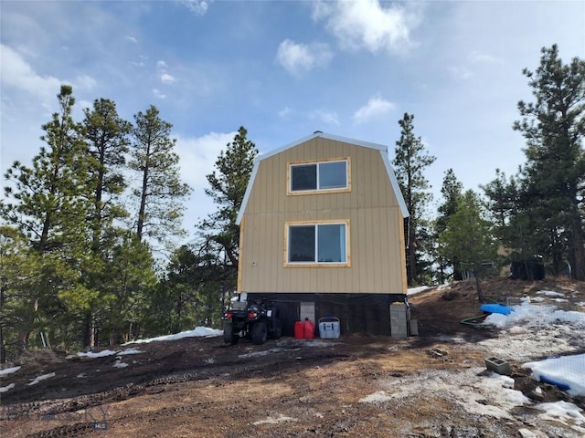 view of property exterior with a gambrel roof
