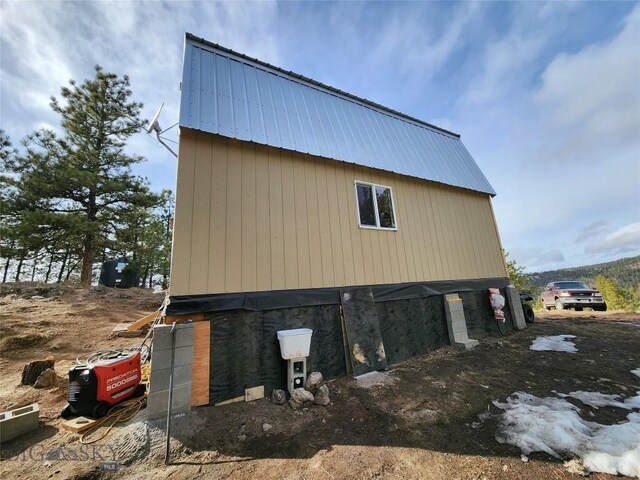 view of side of property with an outbuilding and metal roof