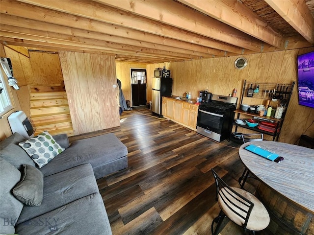 living area with beamed ceiling, dark wood-type flooring, an AC wall unit, and wood walls