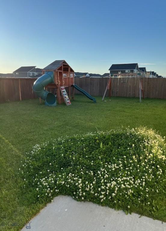 view of yard featuring a fenced backyard and a playground