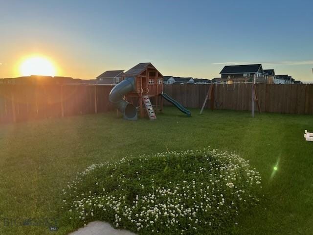 view of yard featuring a fenced backyard and a playground