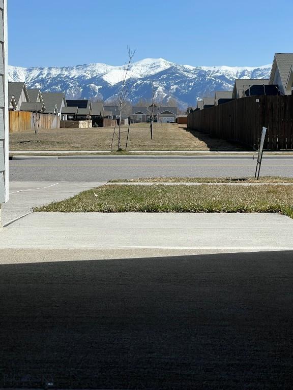 view of road featuring a residential view and a mountain view
