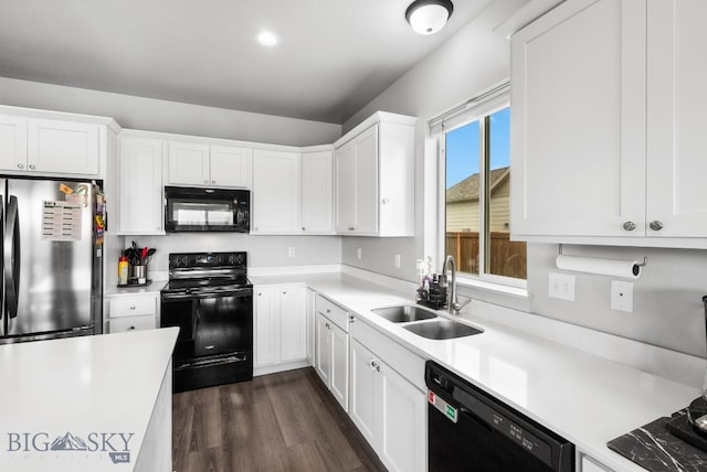 kitchen with dark wood finished floors, light countertops, a sink, black appliances, and white cabinetry