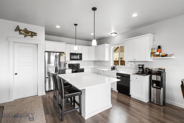 kitchen featuring a sink, white cabinetry, and black appliances