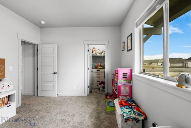 rec room featuring carpet floors and baseboards
