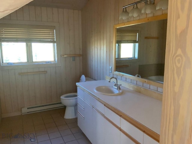36 Rowdy Way, Ennis, MT 59729 - bathroom with baseboard heating, toilet, tile patterned floors, vanity, and wooden walls