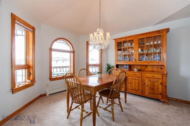 175 Vandyke Rd, Bozeman, MT 59718 - dining room with light colored carpet, baseboard heating, a chandelier, baseboards, and vaulted ceiling