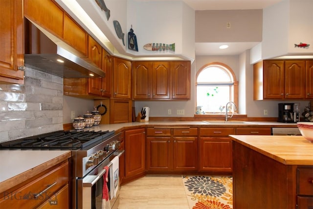 175 Vandyke Rd, Bozeman, MT 59718 - kitchen featuring stainless steel range, wall chimney range hood, a sink, butcher block counters, and brown cabinetry