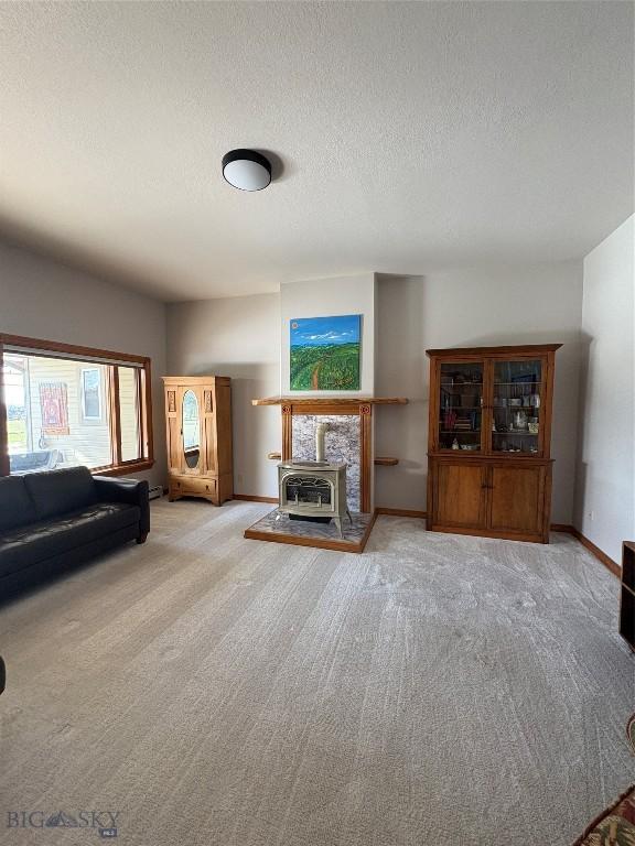 175 Vandyke Rd, Bozeman, MT 59718 - carpeted living area with a textured ceiling and baseboards