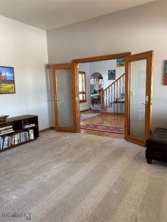 175 Vandyke Rd, Bozeman, MT 59718 - carpeted living room featuring arched walkways, stairway, and baseboards