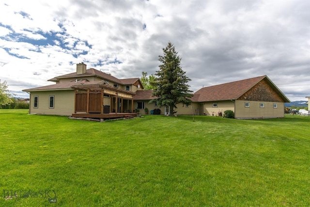 175 Vandyke Rd, Bozeman, MT 59718 - back of house with a deck, a lawn, and a chimney