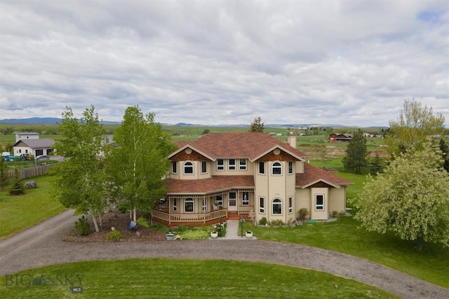175 Vandyke Rd, Bozeman, MT 59718 - view of front of home with curved driveway, a front lawn, a deck, and a chimney