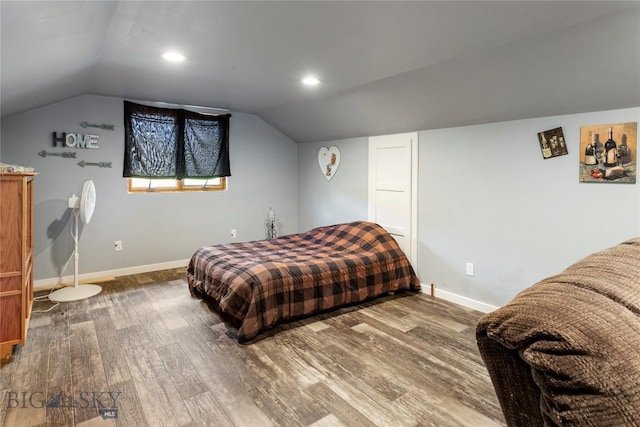 bedroom with lofted ceiling, recessed lighting, wood finished floors, and baseboards