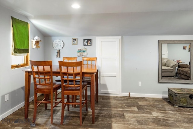 dining area with wood finished floors, baseboards, and vaulted ceiling