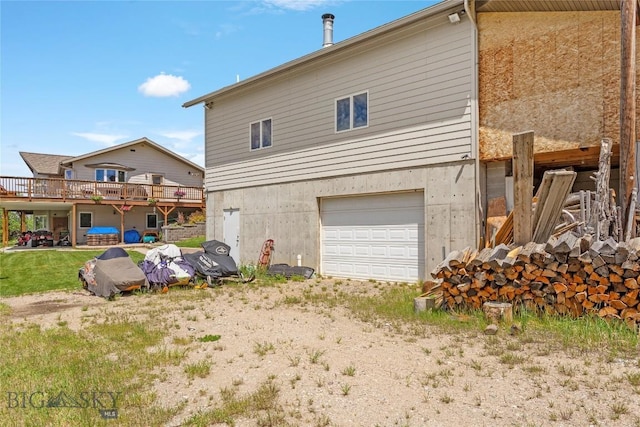 back of property featuring driveway and an attached garage