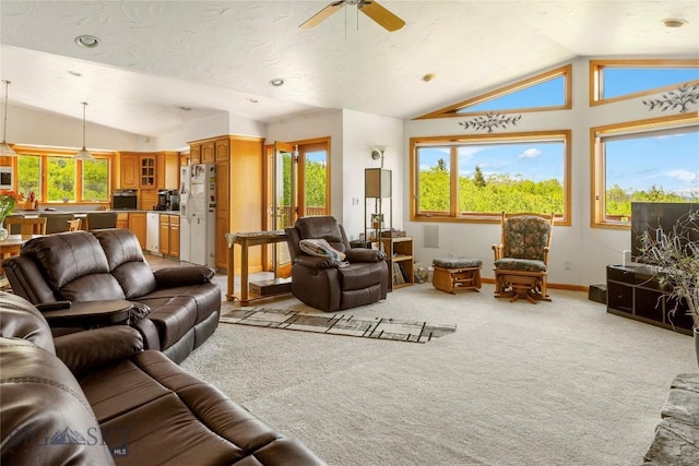 living room with lofted ceiling, light colored carpet, baseboards, and ceiling fan