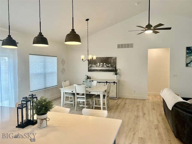42 Wild Rye Pl, Three Forks, MT 59752 - dining area with high vaulted ceiling, light wood-style flooring, ceiling fan, and a chandelier