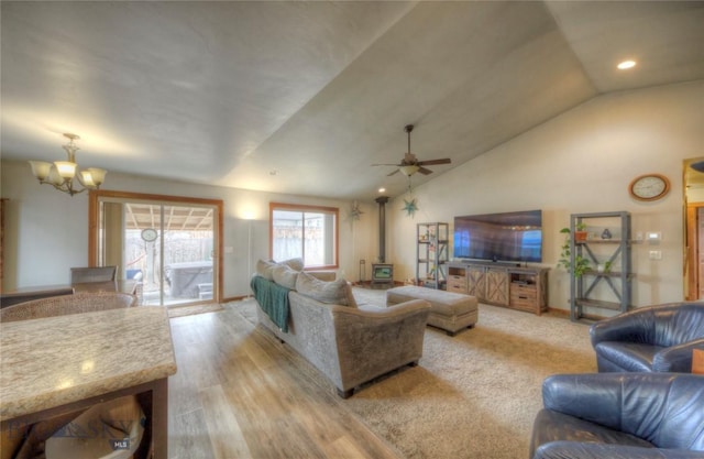 813 Pleiades Pl, Livingston, MT 59047 - living room with a wood stove, light wood-type flooring, ceiling fan with notable chandelier, and lofted ceiling