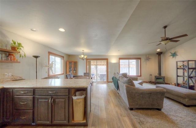 813 Pleiades Pl, Livingston, MT 59047 - living area with light wood-type flooring, a healthy amount of sunlight, a wood stove, and recessed lighting