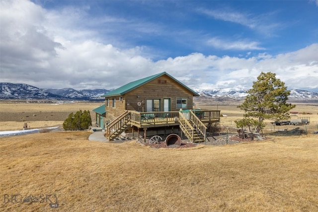 37 Bridger Meadow Ln, Emigrant, MT 59065 - back of house featuring stairway, a deck with mountain view, and a lawn