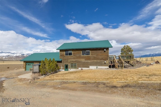37 Bridger Meadow Ln, Emigrant, MT 59065 - view of front facade featuring an attached garage, dirt driveway, and metal roof