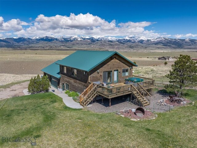 37 Bridger Meadow Ln, Emigrant, MT 59065 - back of property with a deck with mountain view, stairs, and a lawn