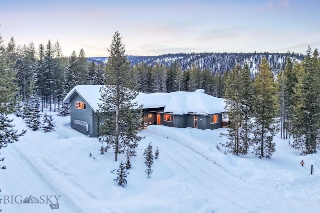 214 W Pine Cone Ter, Big Sky, MT 59716 - snowy aerial view with a wooded view