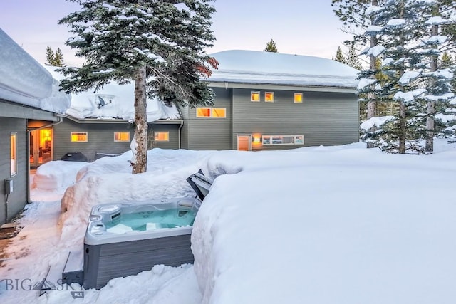 214 W Pine Cone Ter, Big Sky, MT 59716 - snow covered back of property featuring a hot tub