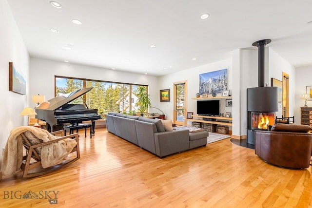 214 W Pine Cone Ter, Big Sky, MT 59716 - living room with light wood finished floors, recessed lighting, and a wood stove