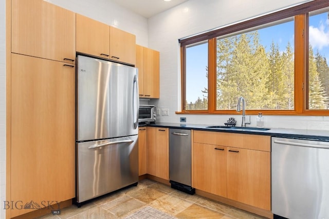 214 W Pine Cone Ter, Big Sky, MT 59716 - kitchen featuring stainless steel appliances, dark countertops, and light brown cabinetry