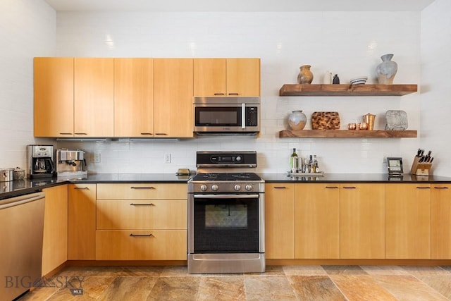 214 W Pine Cone Ter, Big Sky, MT 59716 - kitchen featuring appliances with stainless steel finishes, decorative backsplash, dark countertops, and light stone finish floors