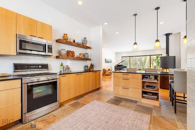 214 W Pine Cone Ter, Big Sky, MT 59716 - kitchen featuring stainless steel appliances, open shelves, dark countertops, stone tile flooring, and modern cabinets