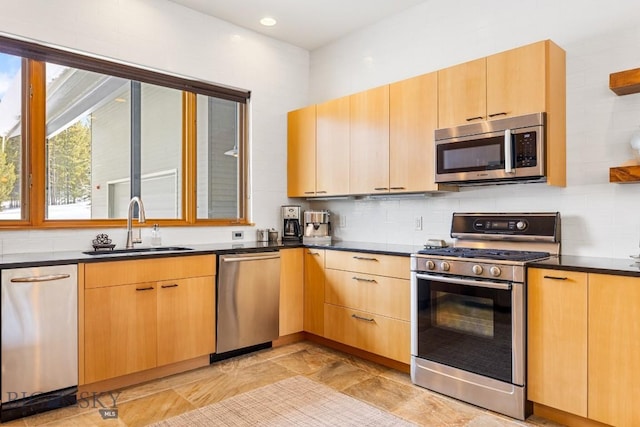 214 W Pine Cone Ter, Big Sky, MT 59716 - kitchen with stainless steel appliances, decorative backsplash, dark countertops, light brown cabinetry, and recessed lighting