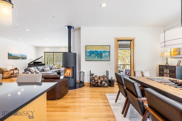 214 W Pine Cone Ter, Big Sky, MT 59716 - living room featuring light wood-style flooring, recessed lighting, and a wood stove