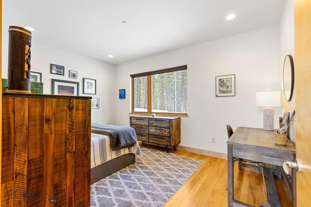 214 W Pine Cone Ter, Big Sky, MT 59716 - bedroom with light wood finished floors and recessed lighting