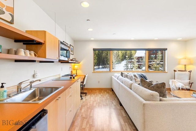214 W Pine Cone Ter, Big Sky, MT 59716 - kitchen with stainless steel microwave, dishwasher, open floor plan, light wood-style flooring, and recessed lighting