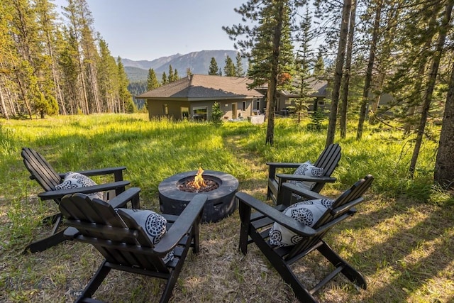214 W Pine Cone Ter, Big Sky, MT 59716 - view of yard featuring an outdoor fire pit and a mountain view