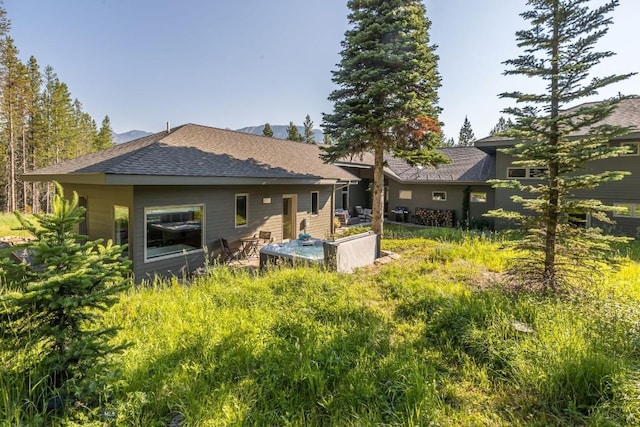 214 W Pine Cone Ter, Big Sky, MT 59716 - rear view of property with roof with shingles