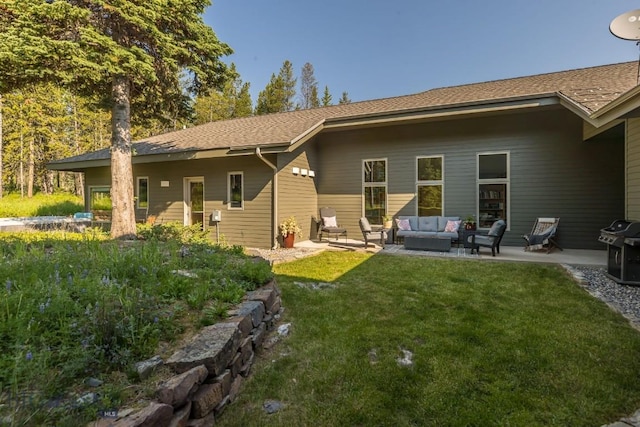 214 W Pine Cone Ter, Big Sky, MT 59716 - rear view of house with an outdoor living space, a lawn, a patio area, and roof with shingles