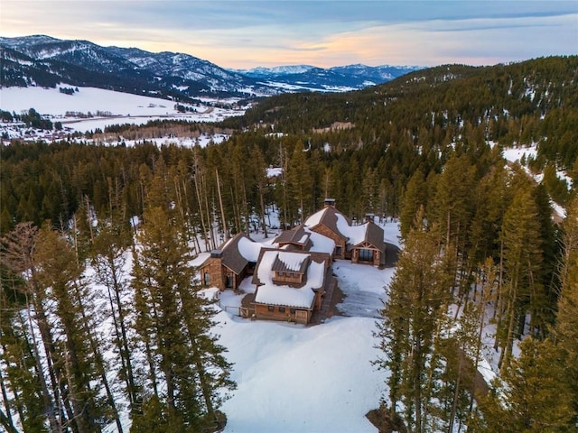 11310 Taiga Trl, Bozeman, MT 59715 - snowy aerial view featuring a mountain view and a forest view