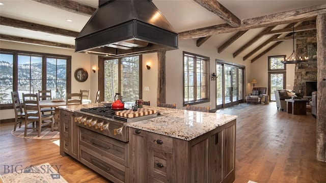 11310 Taiga Trl, Bozeman, MT 59715 - kitchen featuring stainless steel gas cooktop, custom exhaust hood, healthy amount of natural light, light wood-style flooring, and recessed lighting