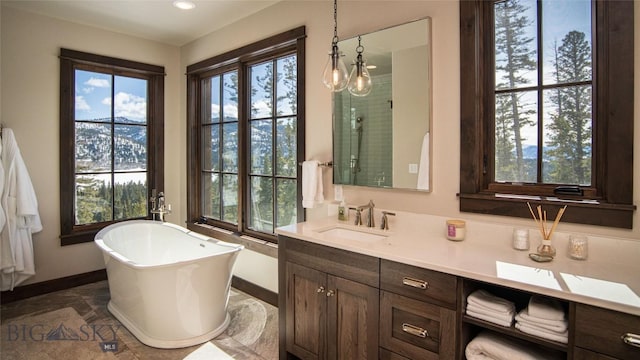 11310 Taiga Trl, Bozeman, MT 59715 - bathroom featuring healthy amount of natural light, a freestanding tub, double vanity, recessed lighting, and an enclosed shower