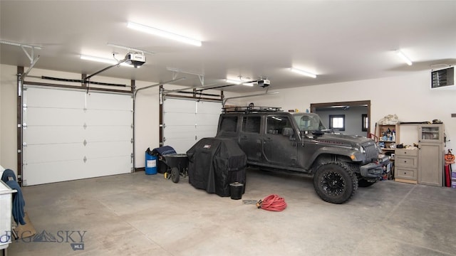 11310 Taiga Trl, Bozeman, MT 59715 - garage featuring a garage door opener and a heating unit