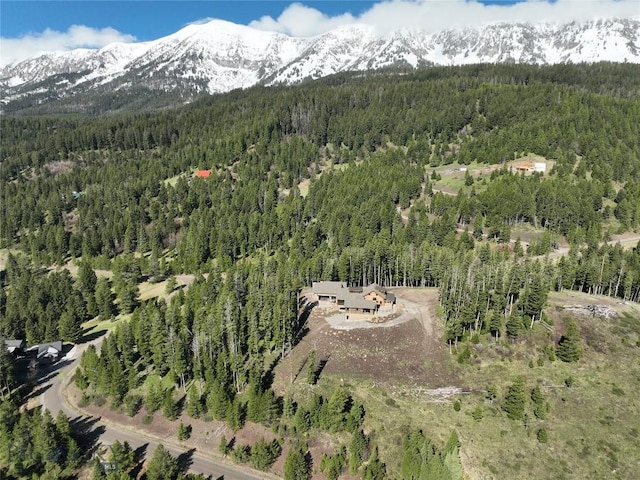 11310 Taiga Trl, Bozeman, MT 59715 - aerial view of property and surrounding area featuring a heavily wooded area and a mountainous background