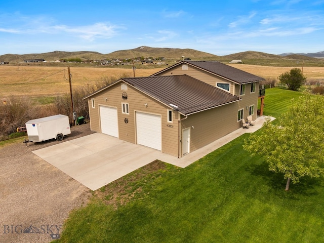 247 Clarks Lookout Rd, Dillon, MT 59725 - view of front of home with a mountain view, a standing seam roof, metal roof, a front lawn, and driveway
