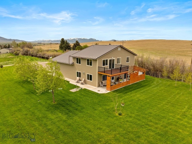 247 Clarks Lookout Rd, Dillon, MT 59725 - rear view of house with a patio, a standing seam roof, a lawn, metal roof, and a deck with mountain view