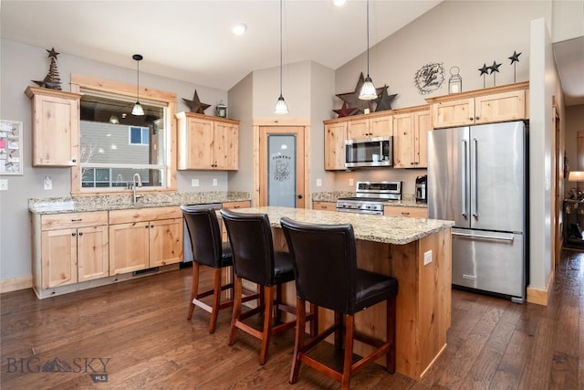 154 Nellie Ct, Manhattan, MT 59741 - kitchen with stainless steel appliances, light brown cabinets, a sink, a kitchen island, and high vaulted ceiling