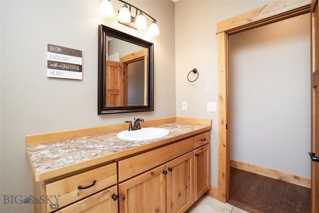 154 Nellie Ct, Manhattan, MT 59741 - bathroom featuring vanity, baseboards, and wood finished floors