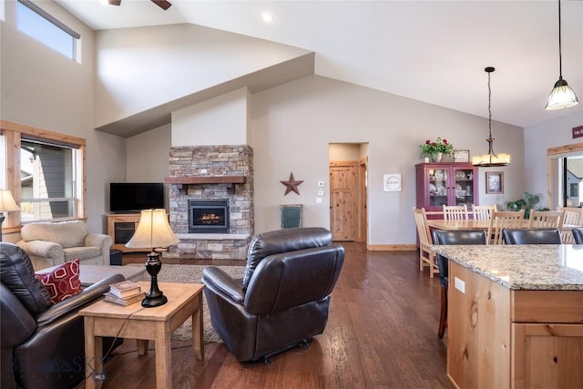 154 Nellie Ct, Manhattan, MT 59741 - living area with dark wood-style flooring, high vaulted ceiling, ceiling fan, a stone fireplace, and baseboards